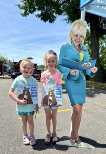 Children standing next to Dolly Parton cutout