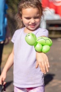 Girl with a turtle balloon animal
