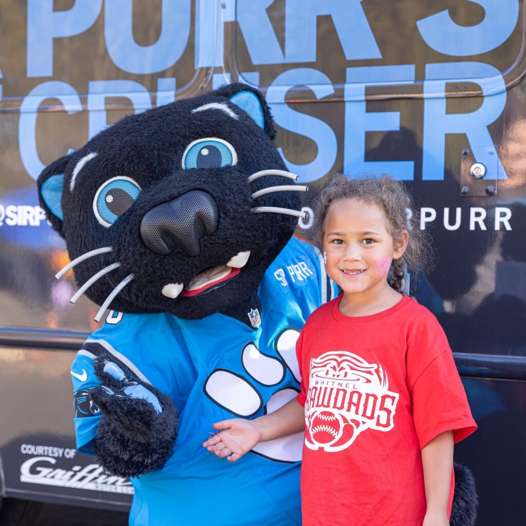 Girl standing with Sir Purr