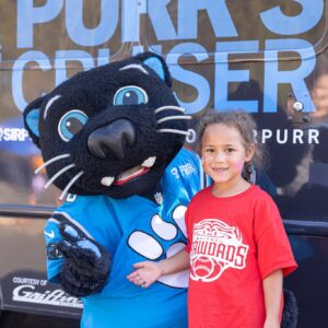 Girl standing with Sir Purr