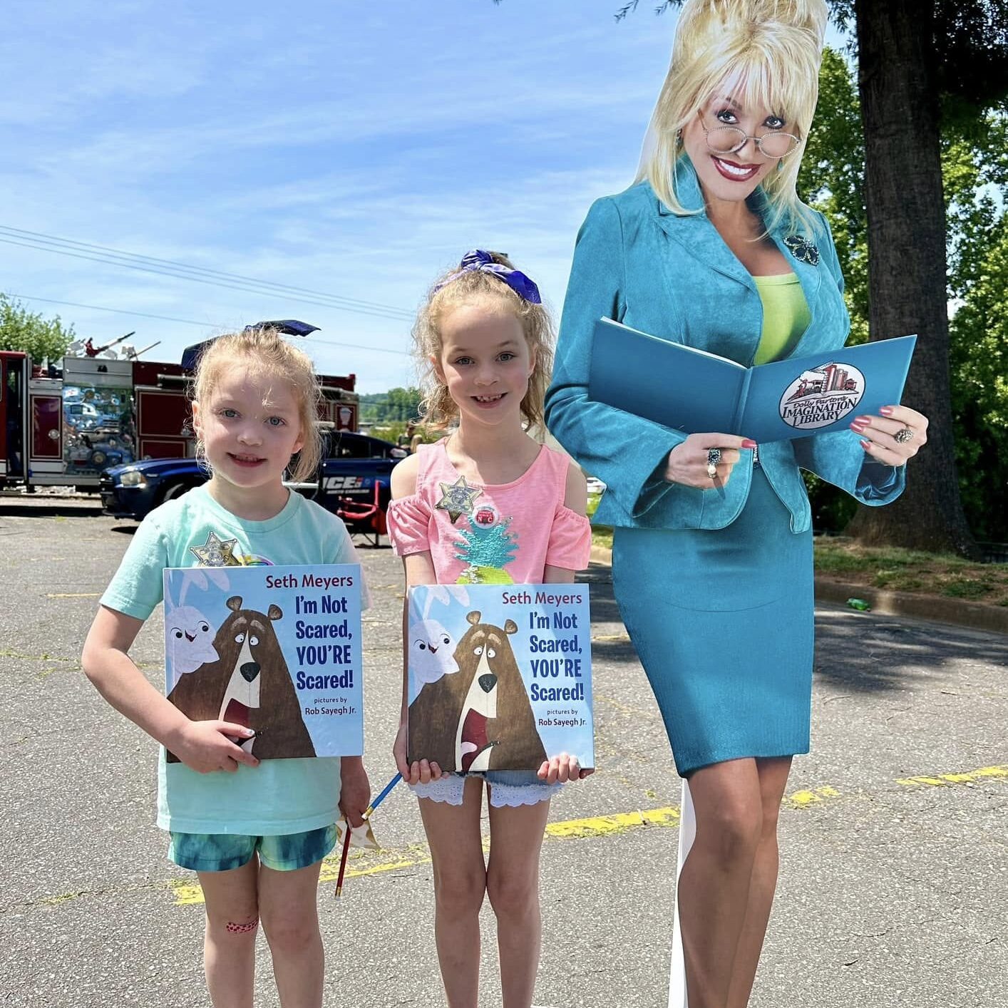 Children standing next to Dolly Parton cutout