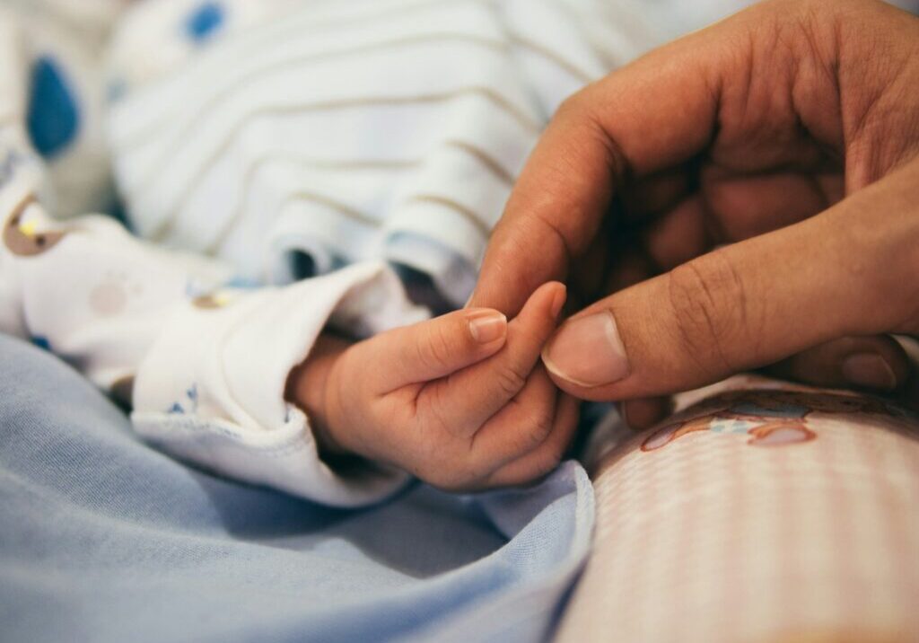 Photo by Aditya Romansa person holding baby's index finger