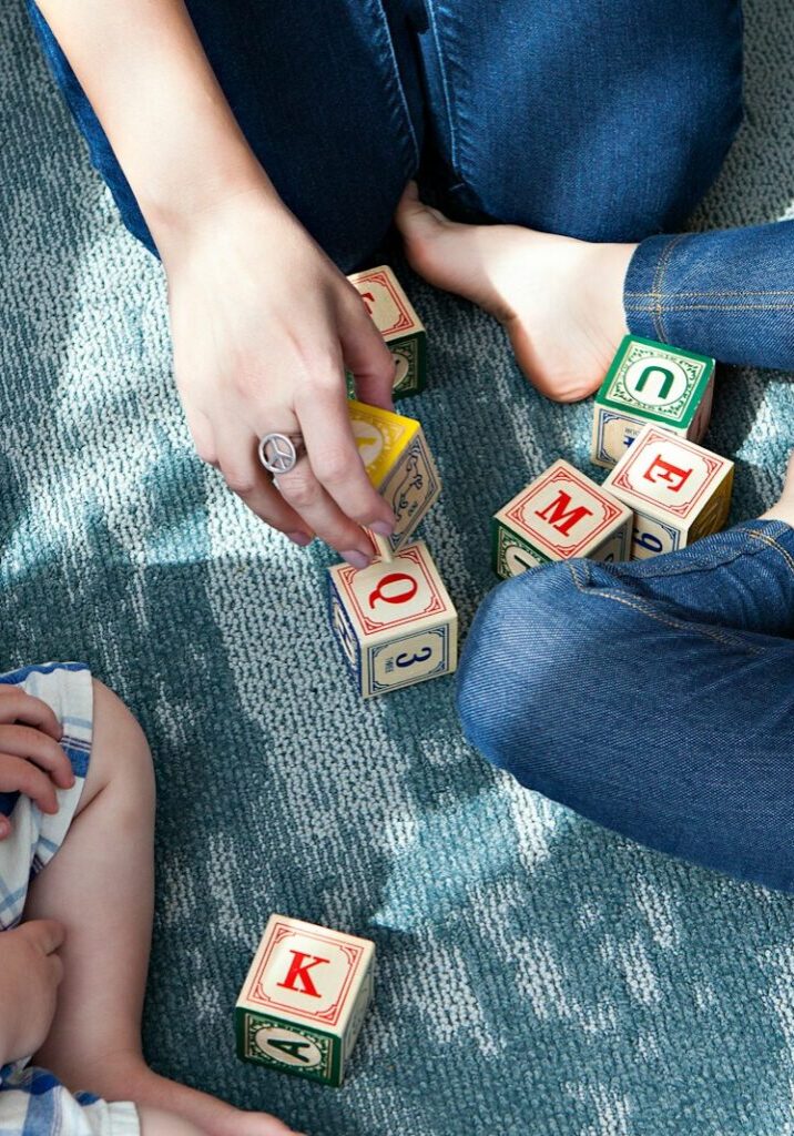 Photo by Marisa Howenstine two toddler playing letter cubes